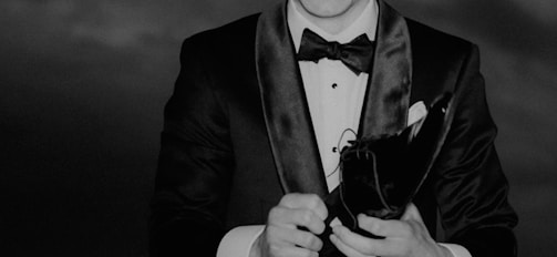 a black and white photo of a man in a tuxedo