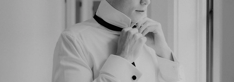 Woman in a white shirt and black tie