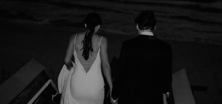 a man and a woman walking down an escalator