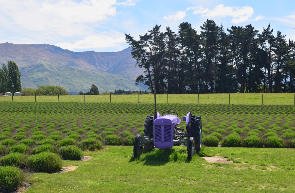 a tractor parked in a field with mountains in the background