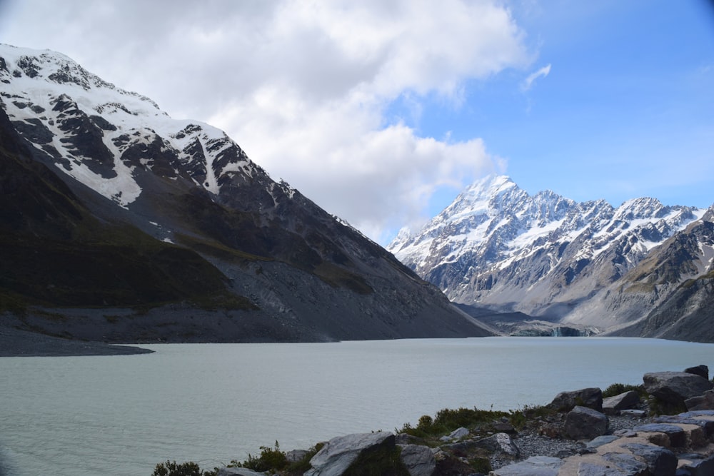 a view of a mountain range with a lake in the foreground