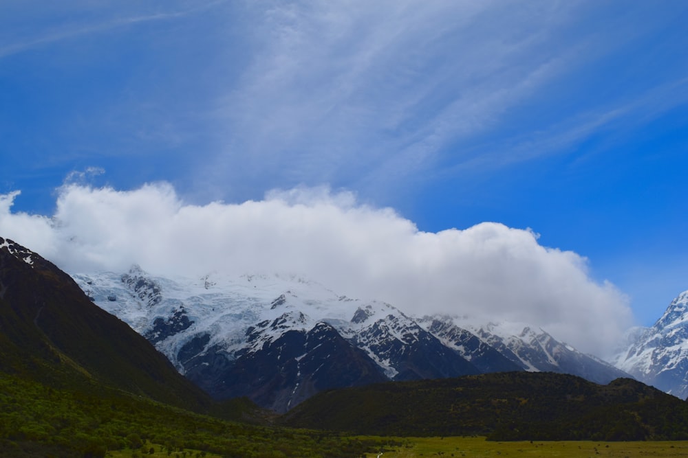 a mountain range with snow capped mountains in the background