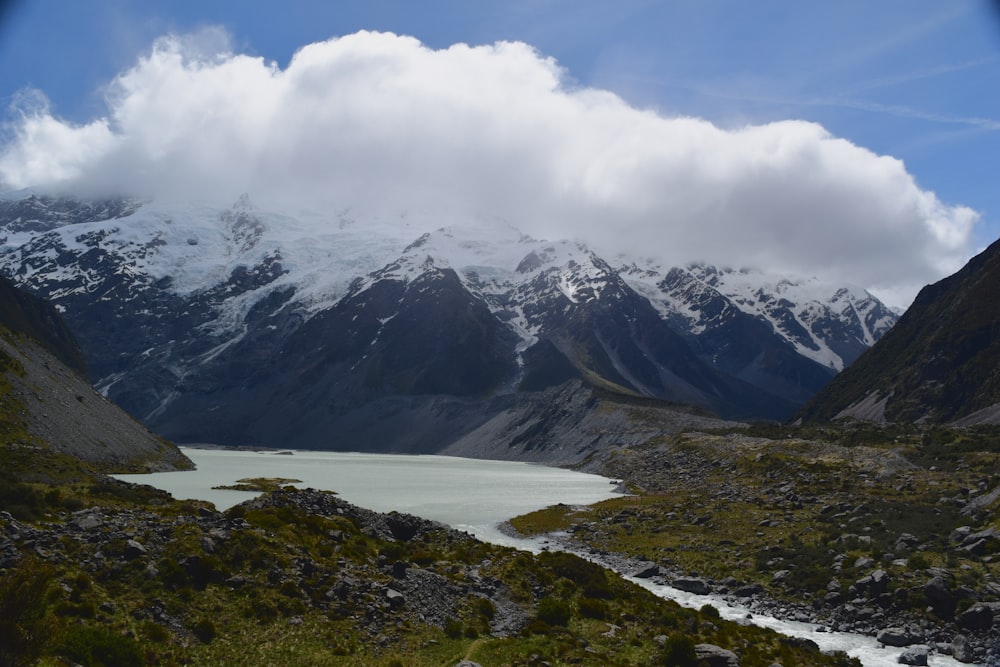 a mountain range with a body of water in the foreground