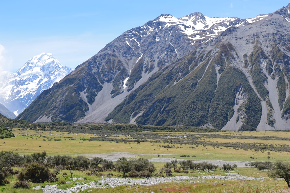 a mountain range with snow capped mountains in the background