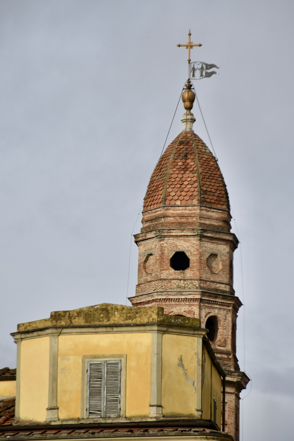 a tall tower with a cross on top of it