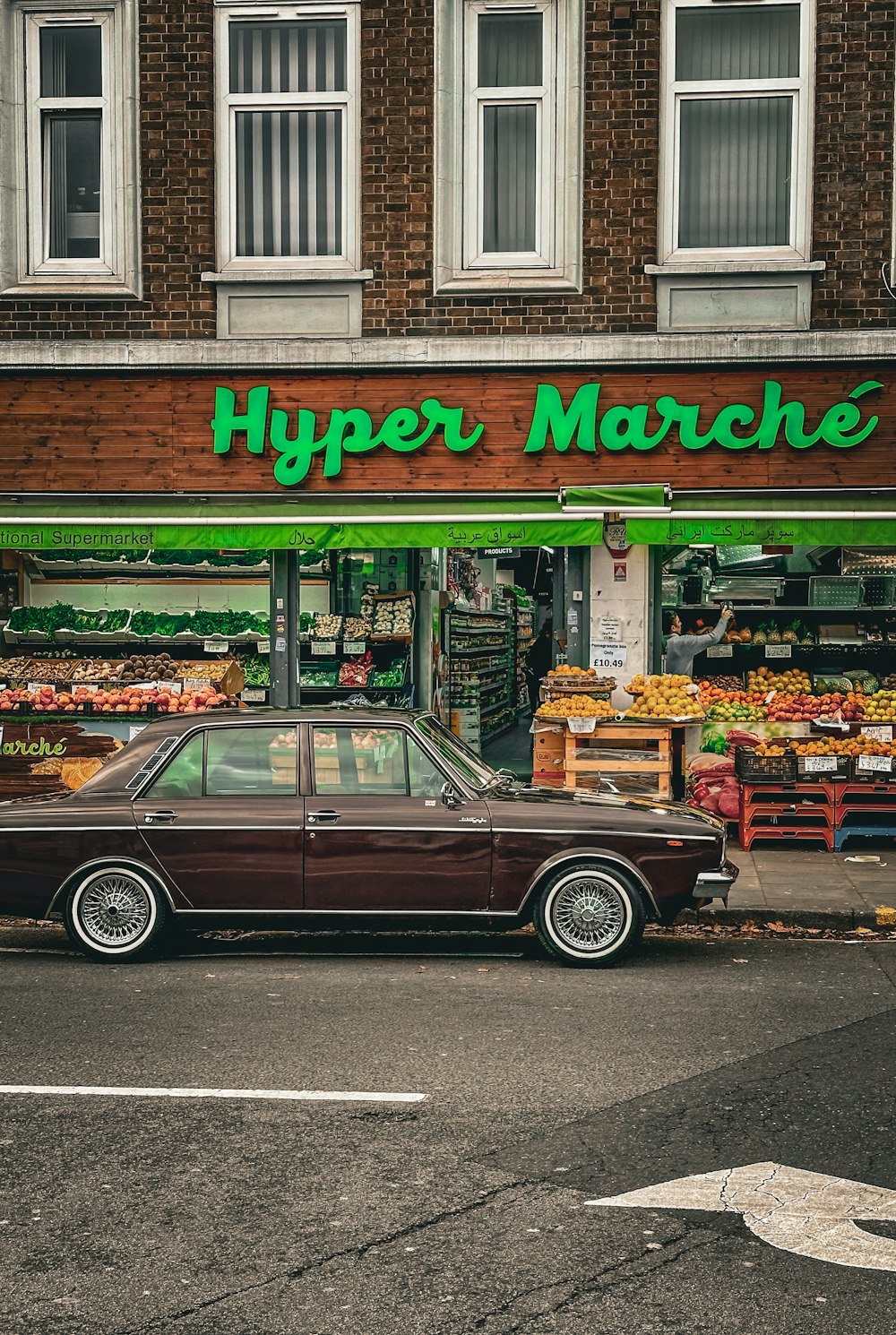 a brown car parked in front of a store
