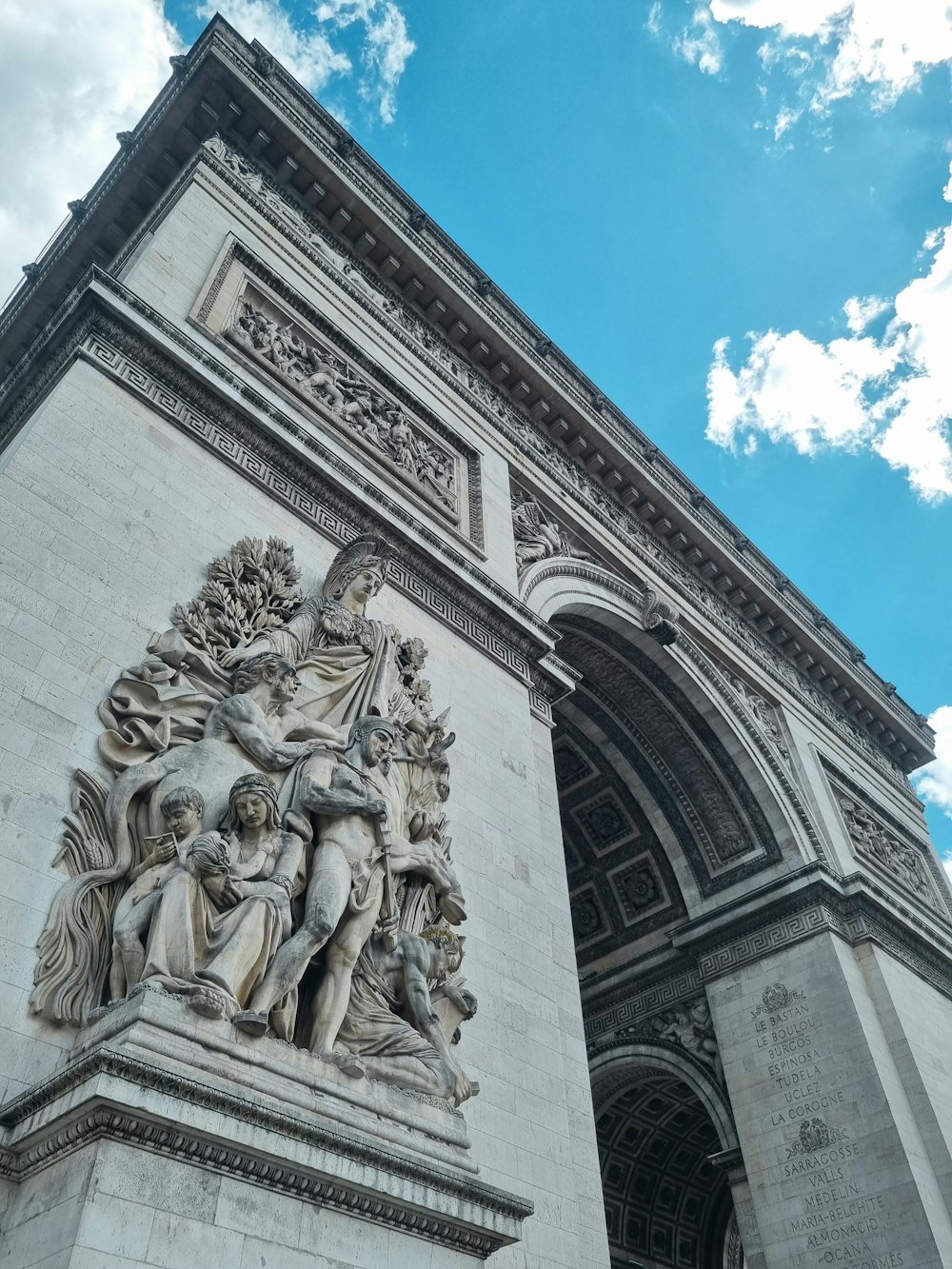 a very tall building with a statue on it's side