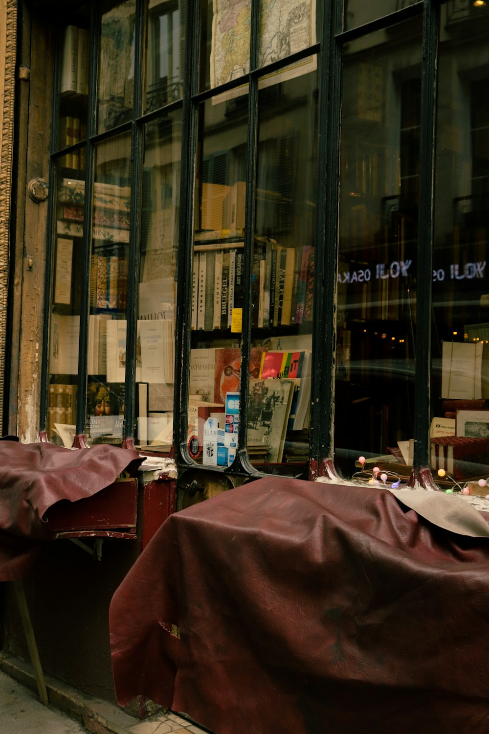 a store front with a red tarp covering the windows