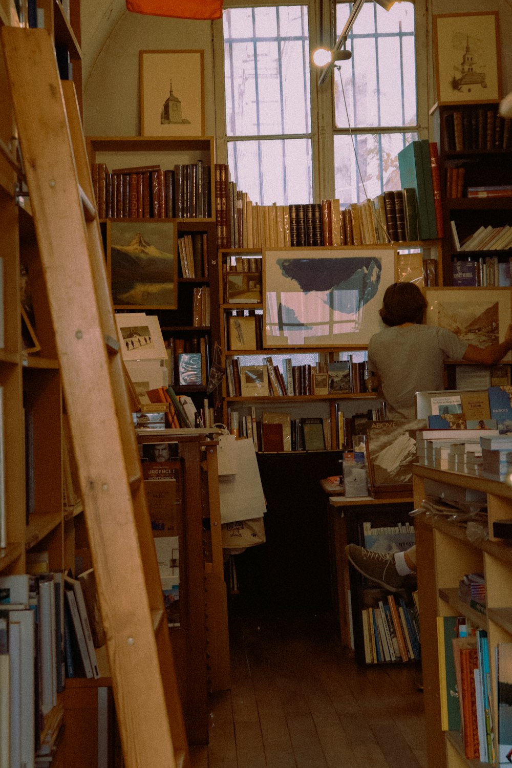 a room filled with lots of books and a ladder