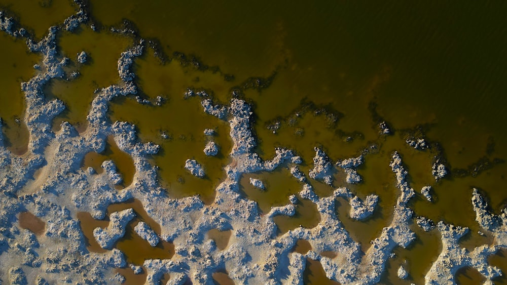 an aerial view of a body of water covered in snow