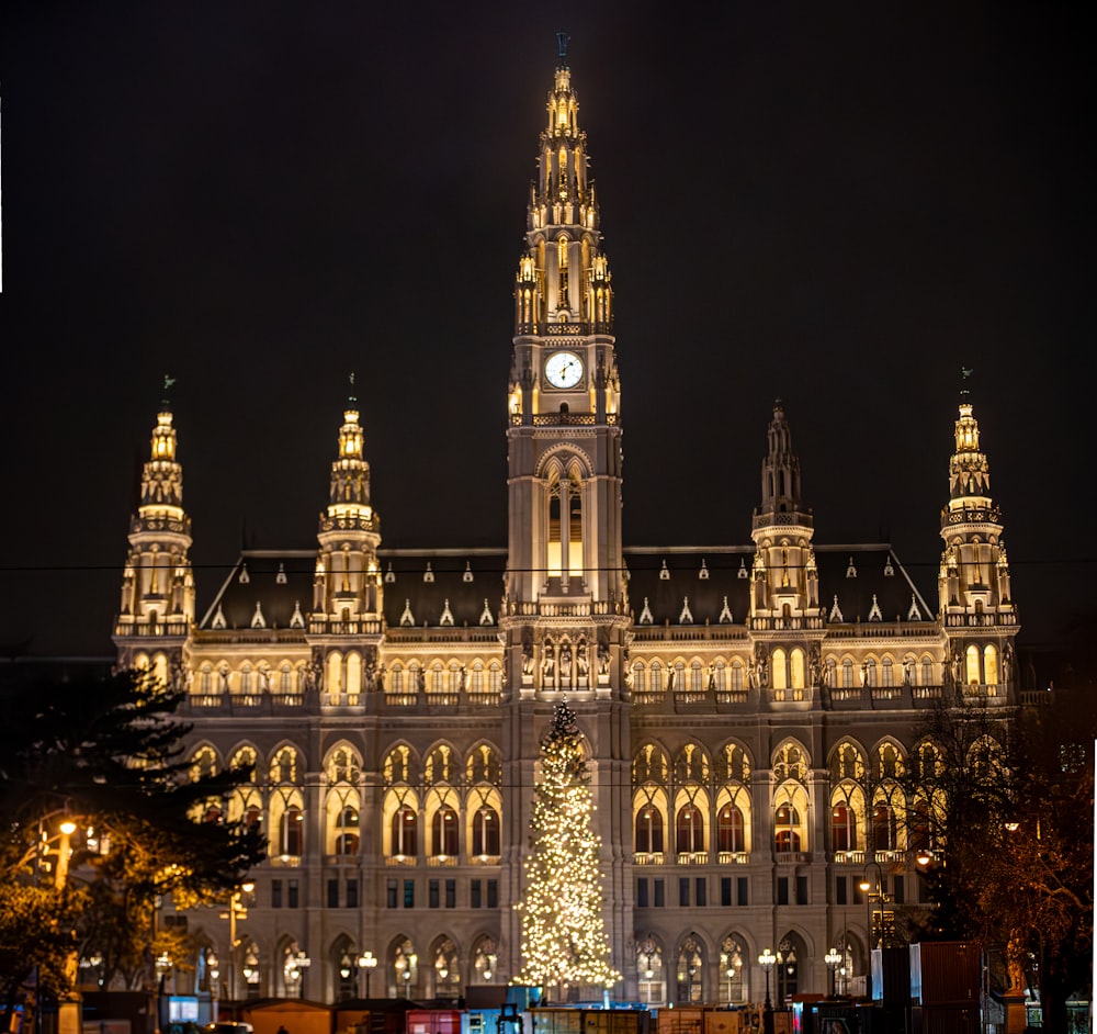 a large building with a christmas tree in front of it