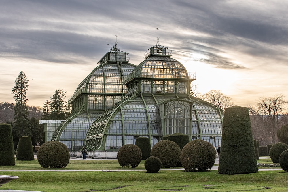 a large glass building surrounded by lots of trees