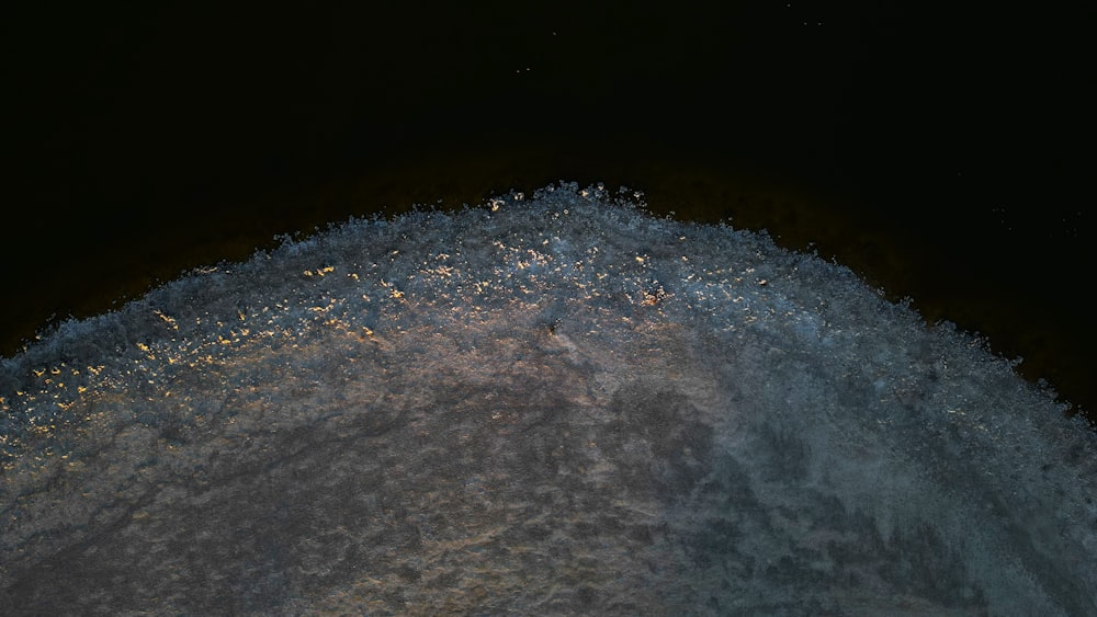 a close up of a snow covered hill at night