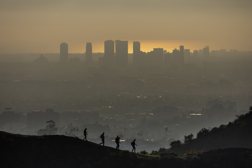 a group of people standing on top of a hill