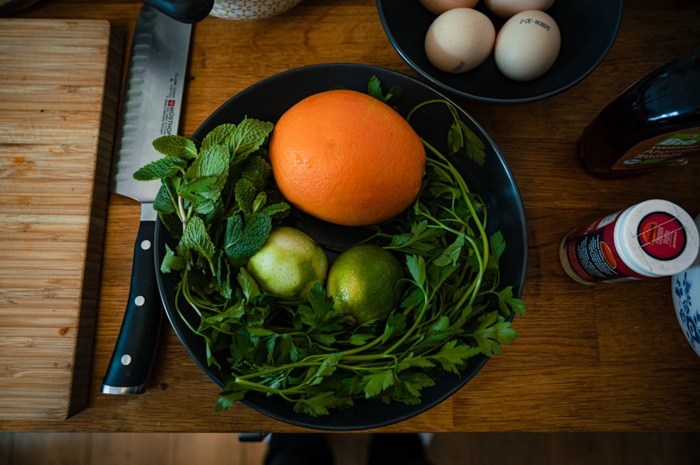 a bowl of fruit and vegetables on a table