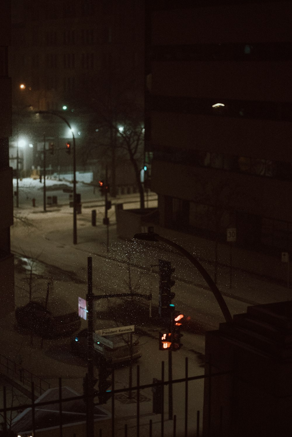 a city street at night with traffic lights