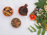 three small bowls filled with different types of flowers