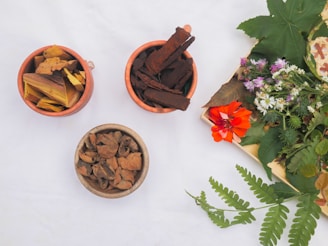 three small bowls filled with different types of flowers