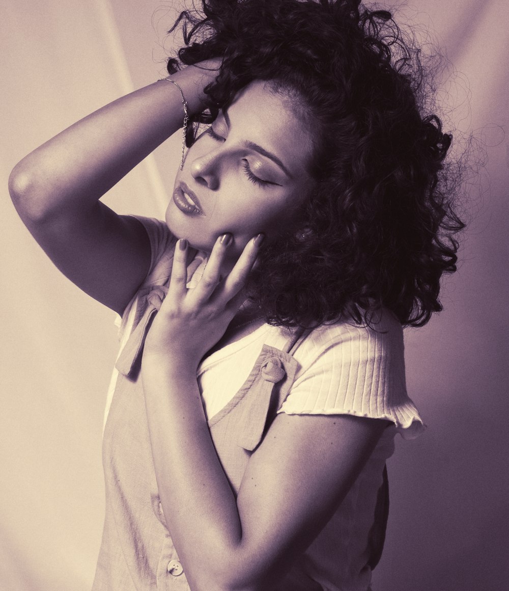 a black and white photo of a woman with curly hair