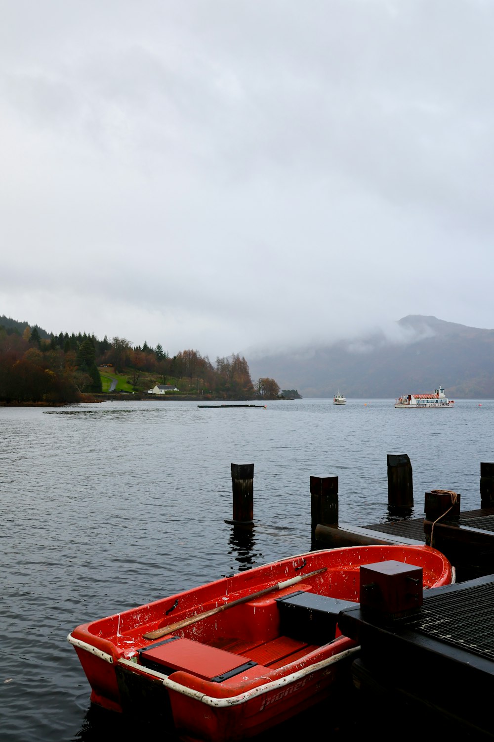 a red boat sitting on top of a body of water