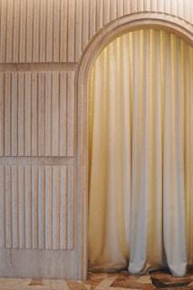 a room with a door and a curtain