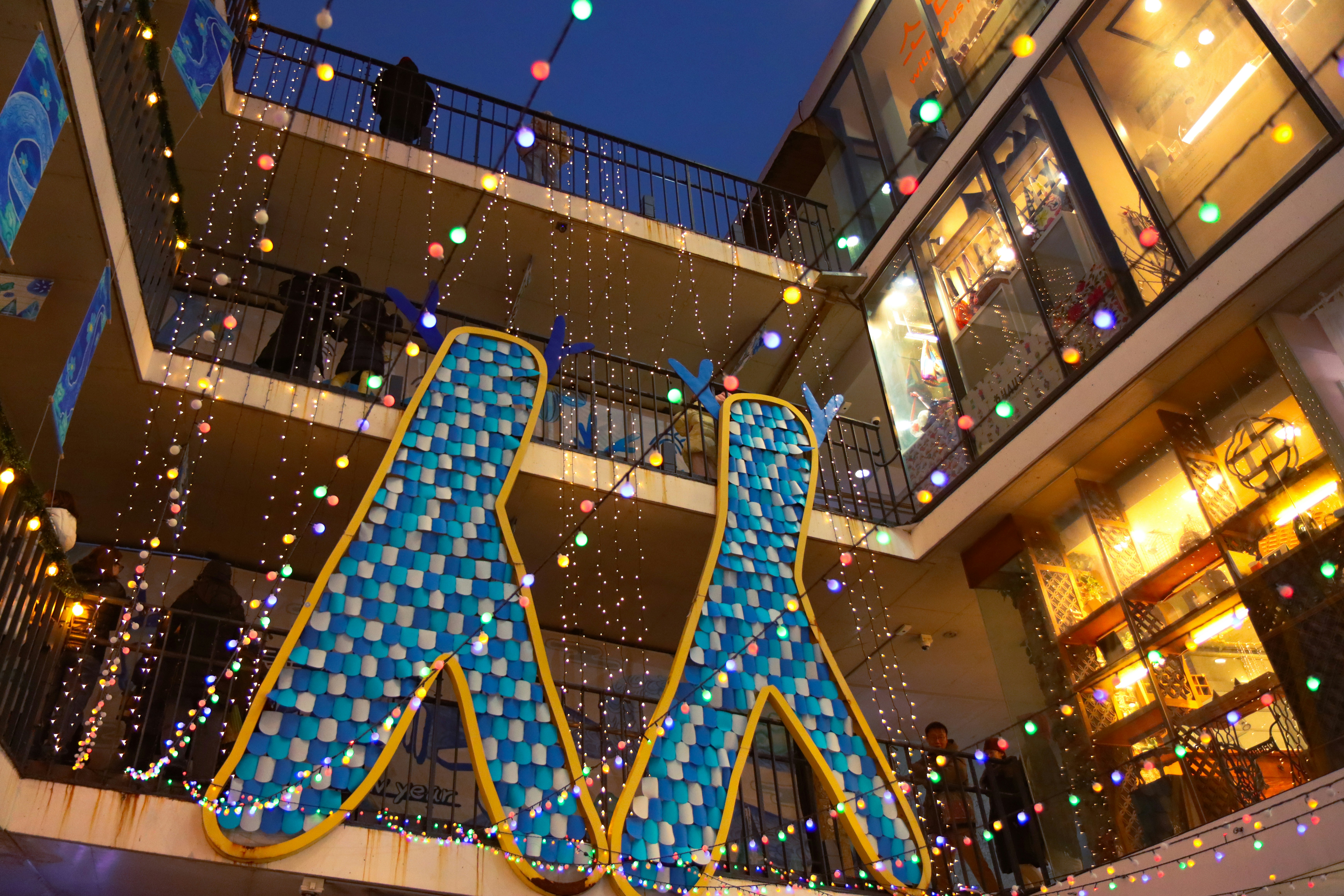 a large blue and yellow sign in front of a building