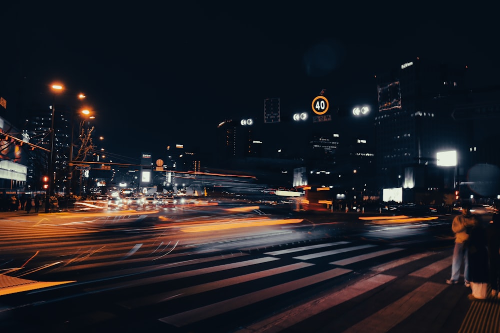 a city street at night with a lot of traffic