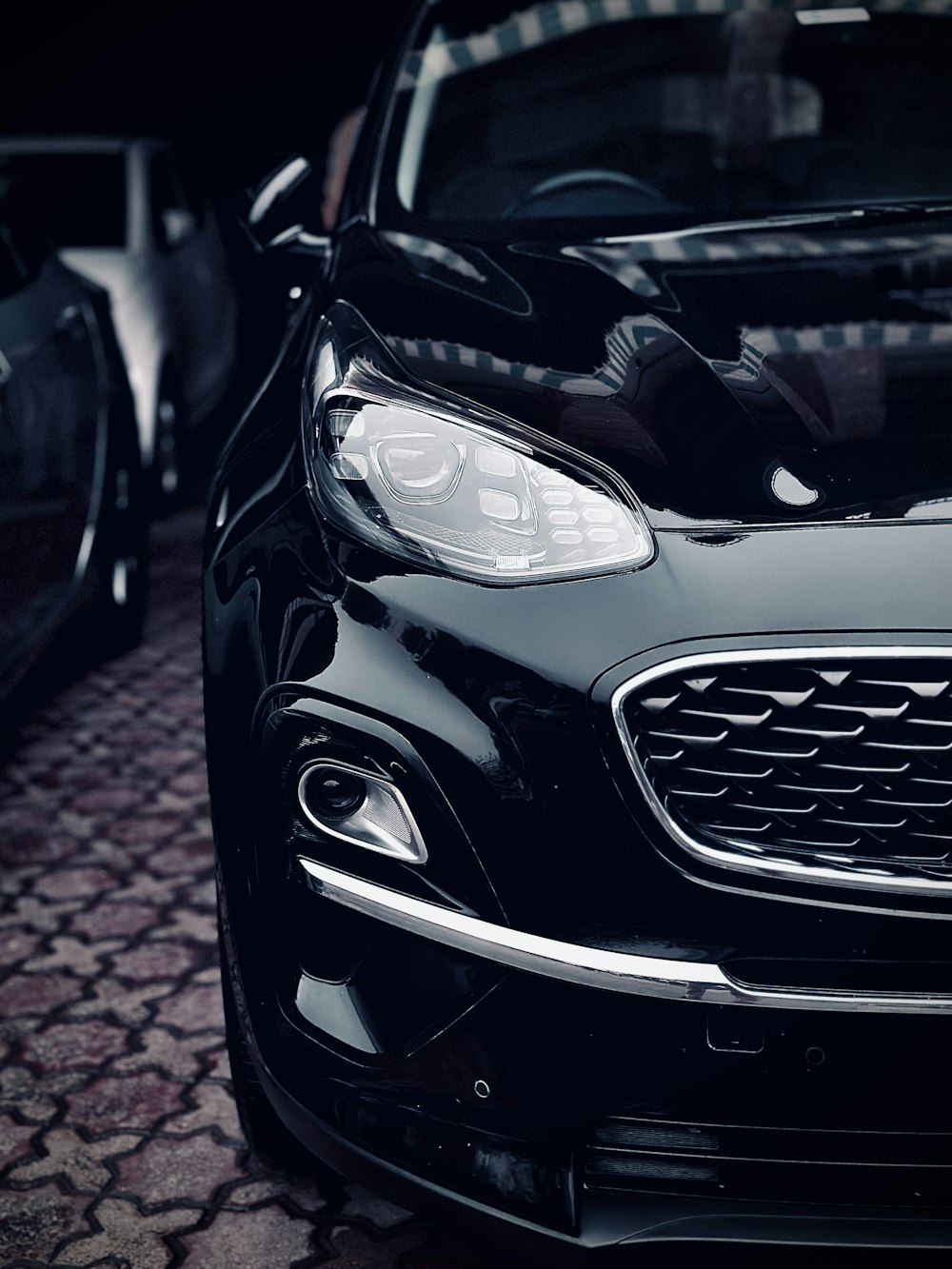 a close up of a car on a cobblestone street