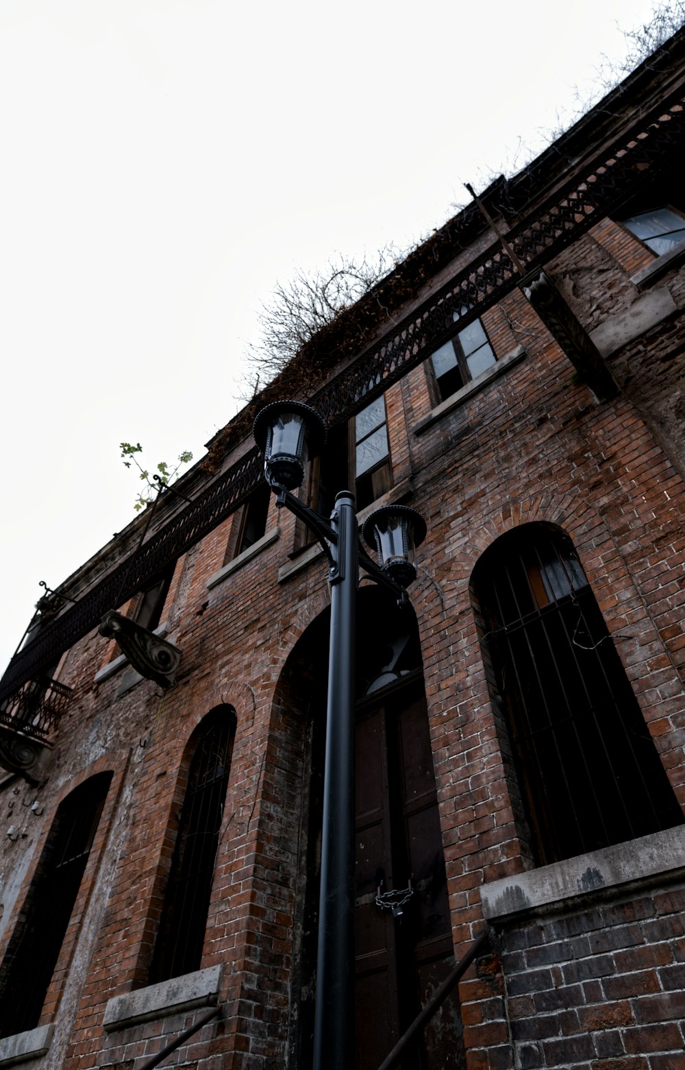 a street light in front of a brick building