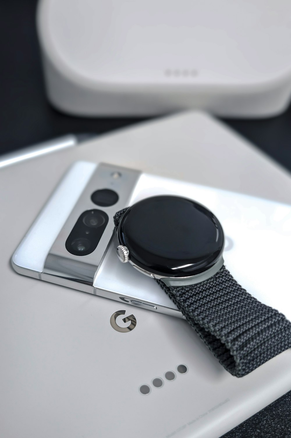 a smart watch sitting on top of a smart phone