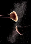 a close up of a makeup brush on a black background
