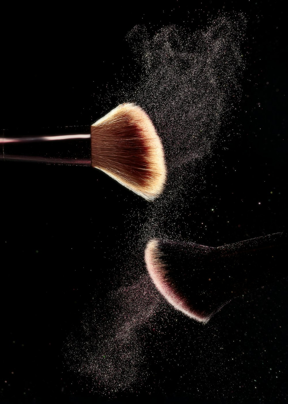 a close up of a makeup brush on a black background