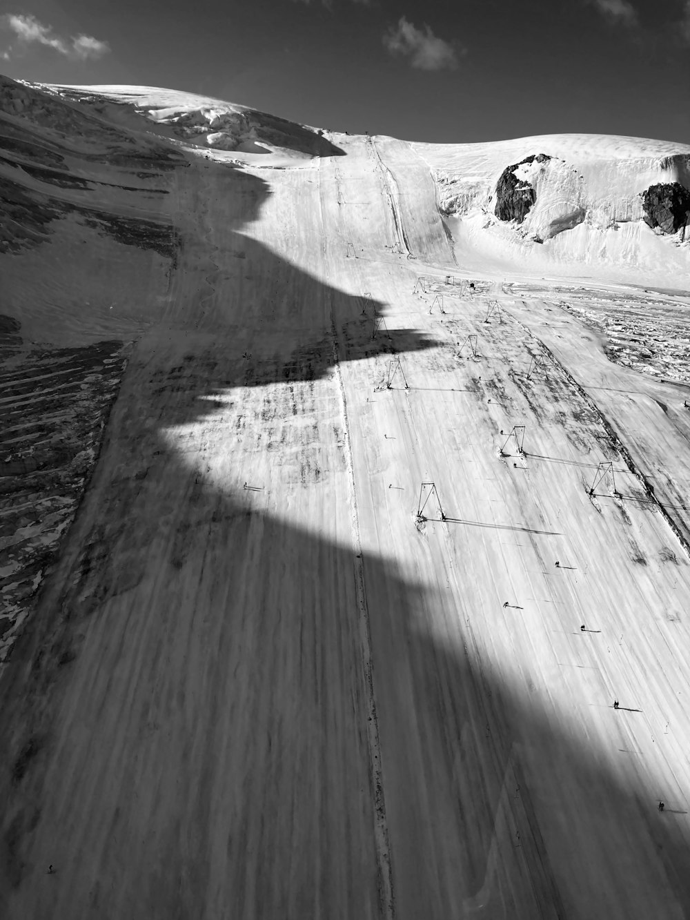 a black and white photo of a snow covered mountain