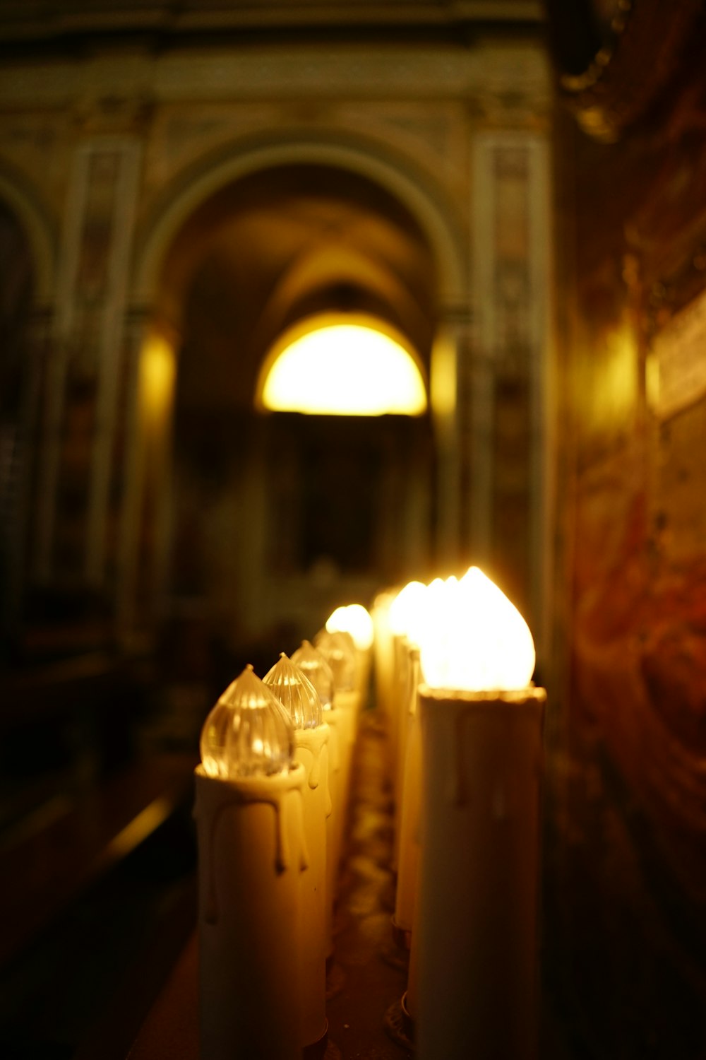 a row of lit candles sitting on top of a table