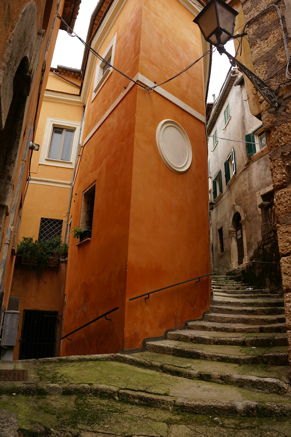 an orange building with a round window on the side of it