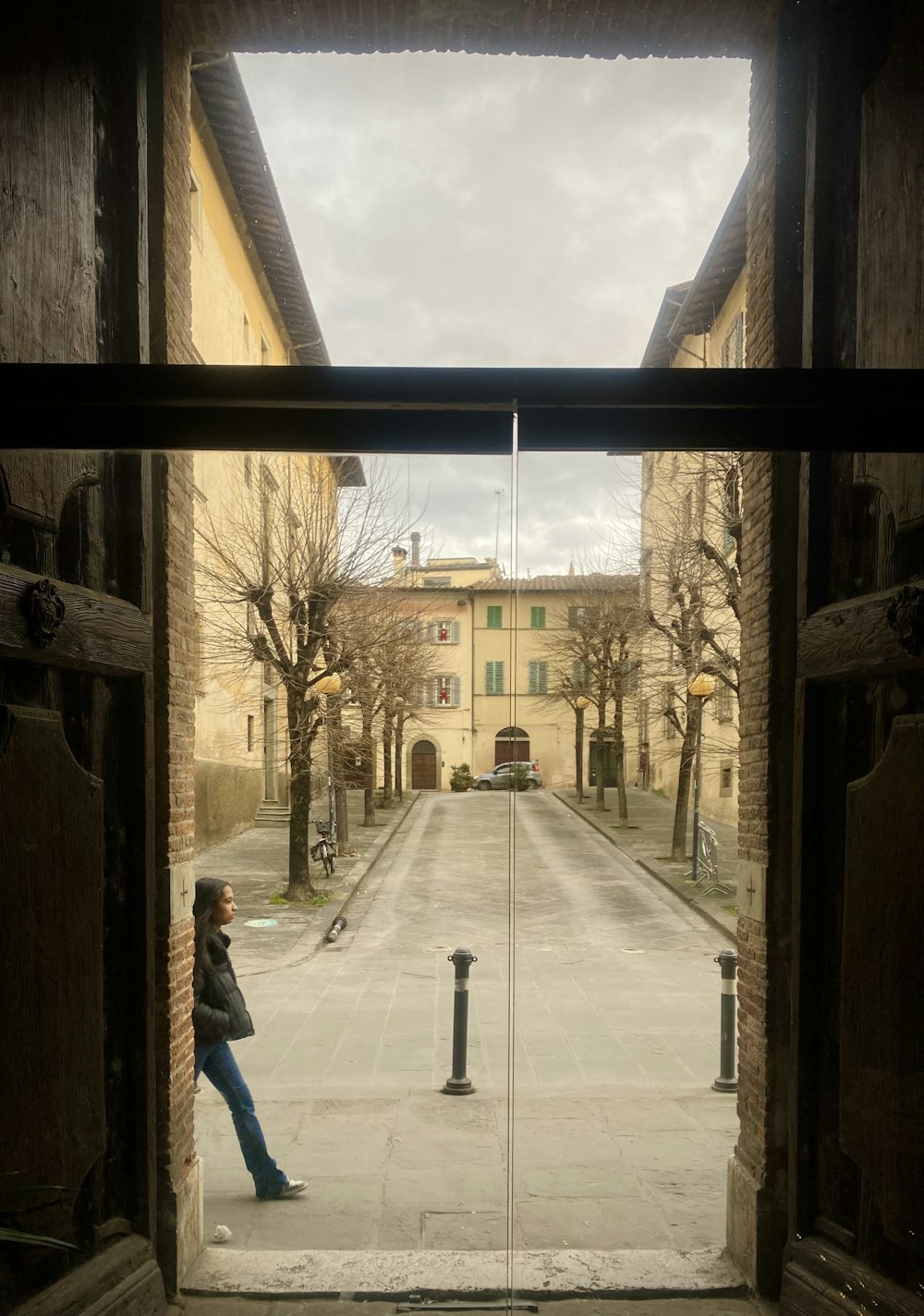 a woman standing in an open doorway in a building