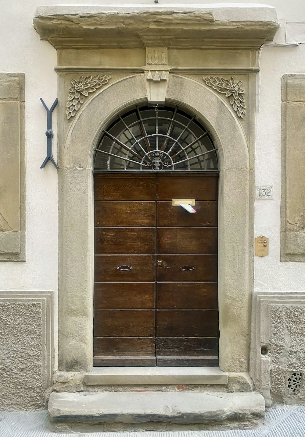 a large wooden door with a window above it