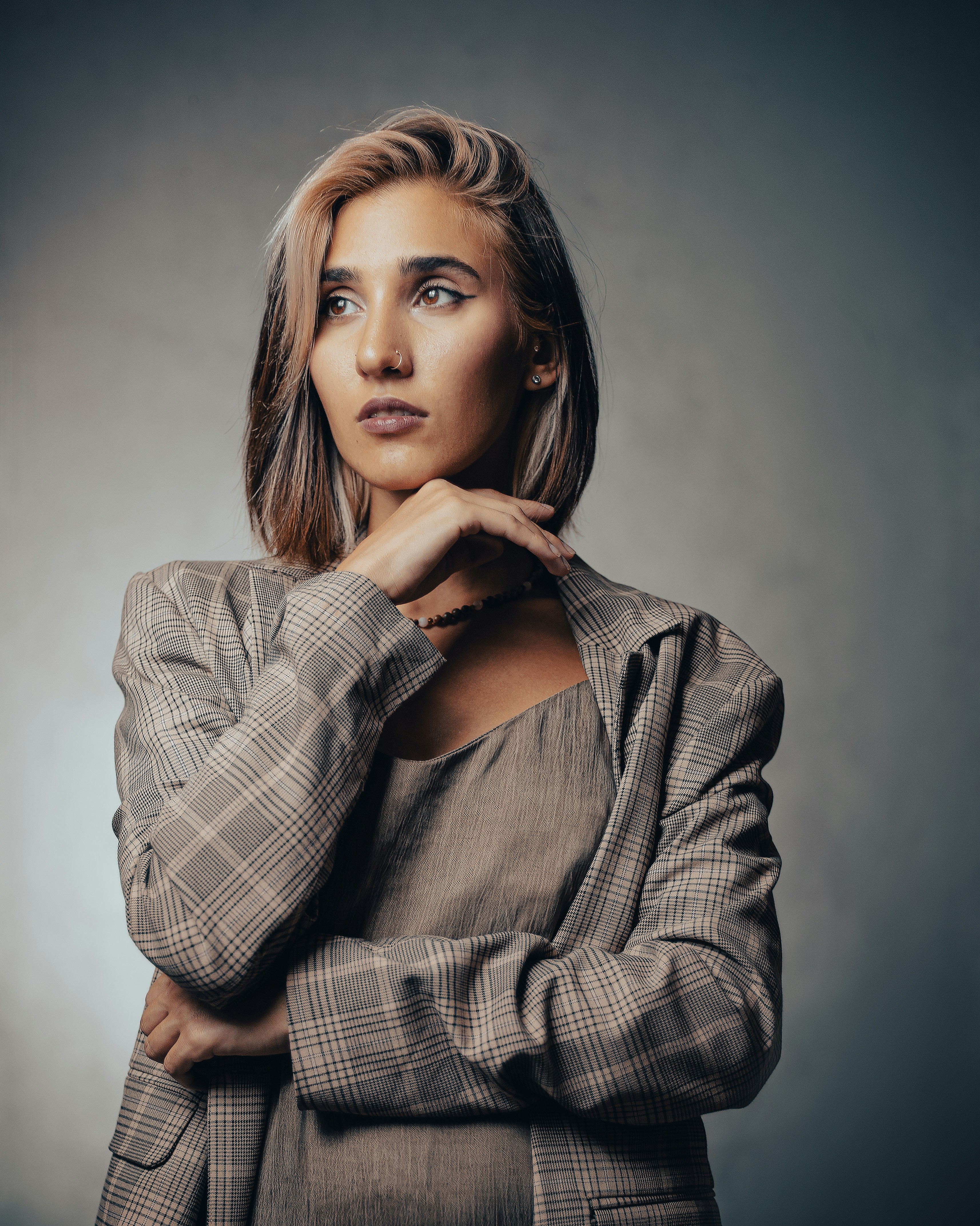 a woman posing for a picture with her hand on her chin