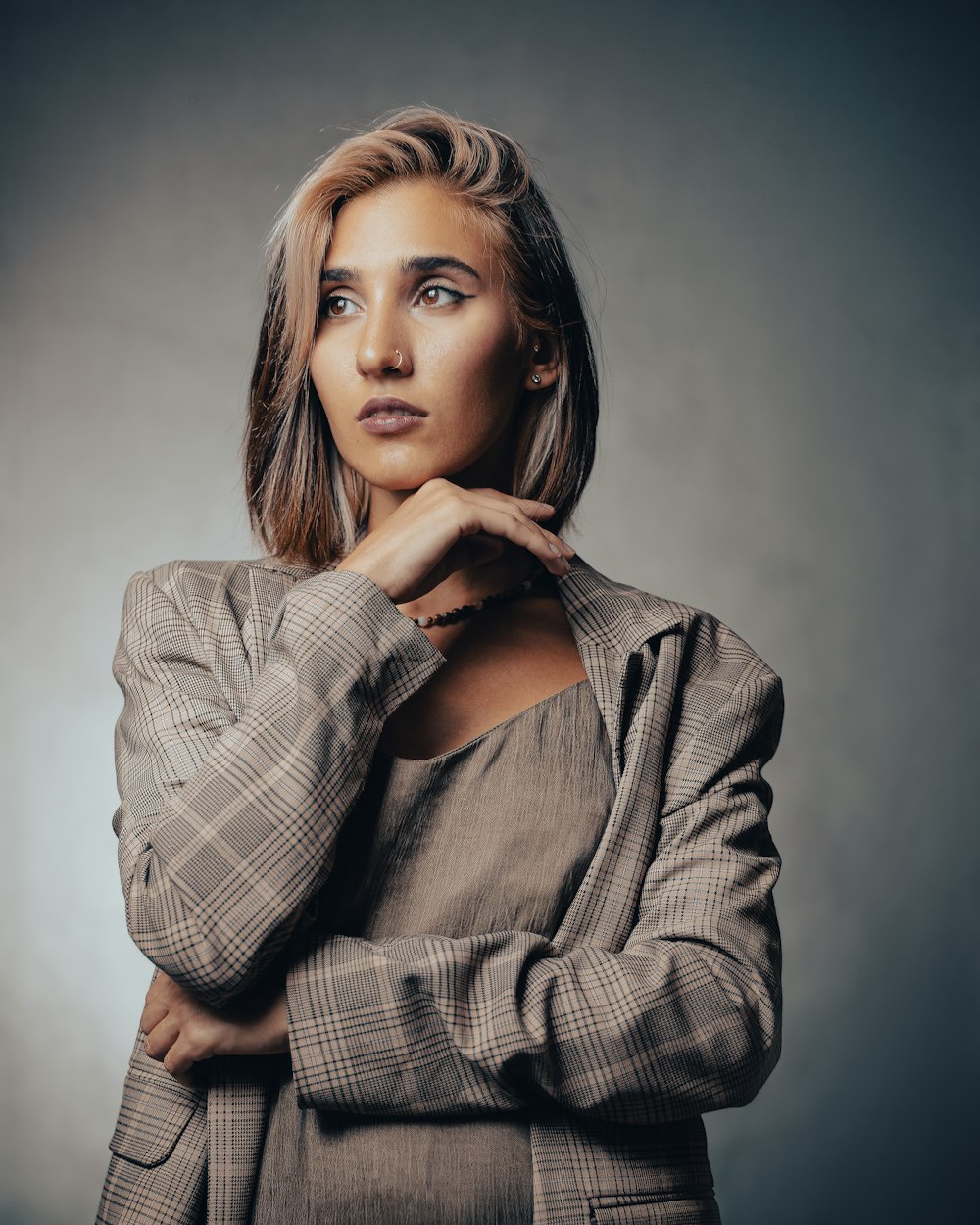 a woman posing for a picture with her hand on her chin