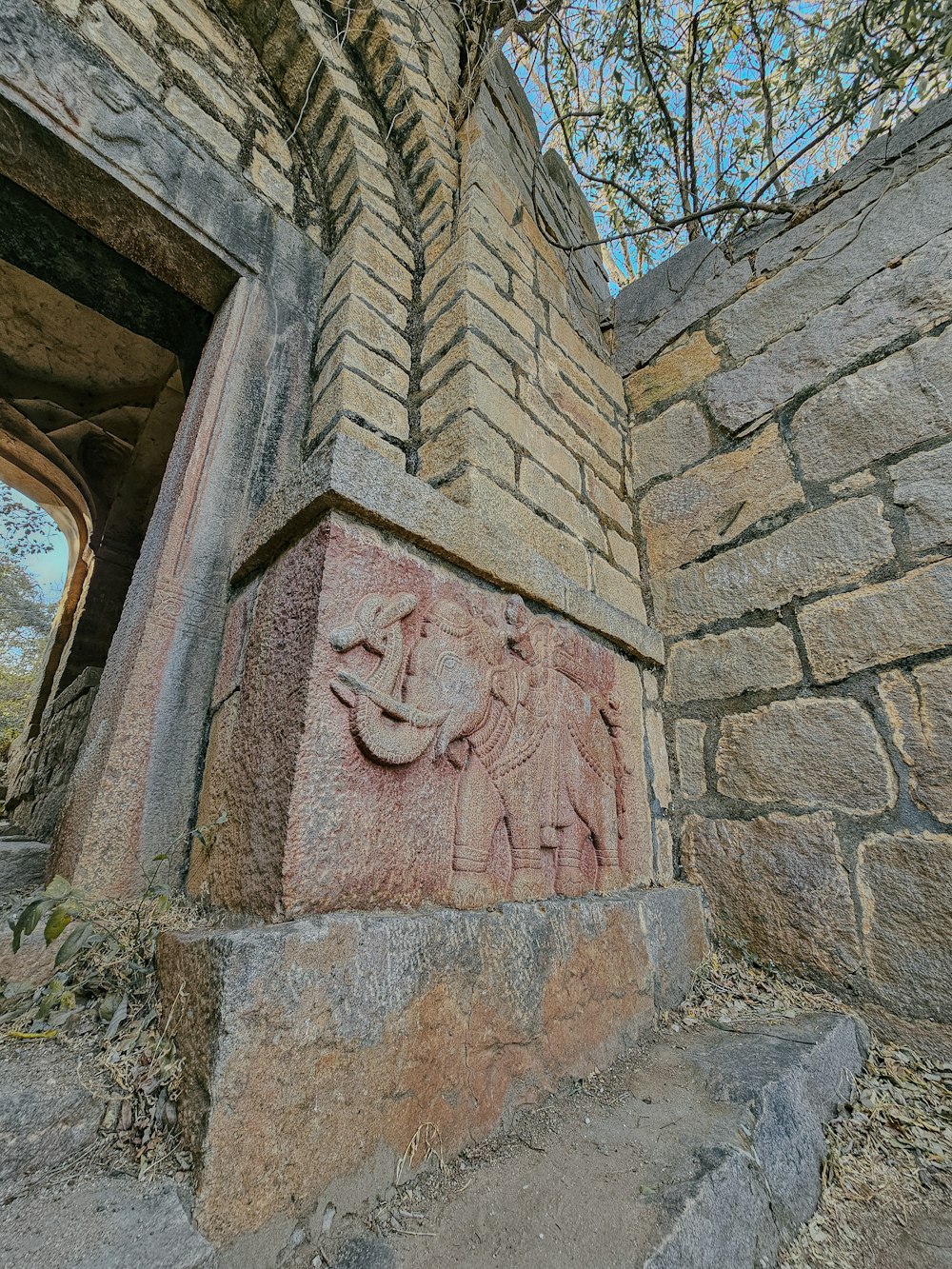 a brick wall with a carved elephant on it