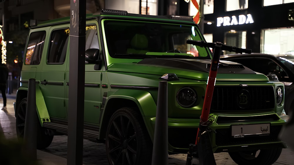 a green jeep parked on the side of a street