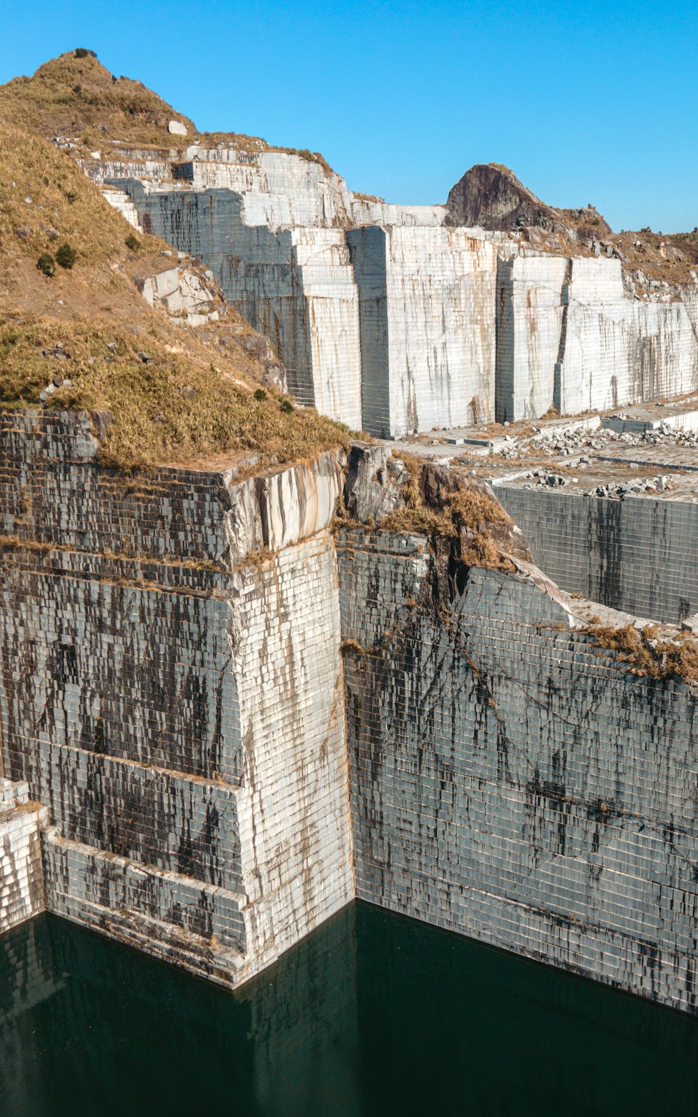 a large body of water surrounded by cliffs