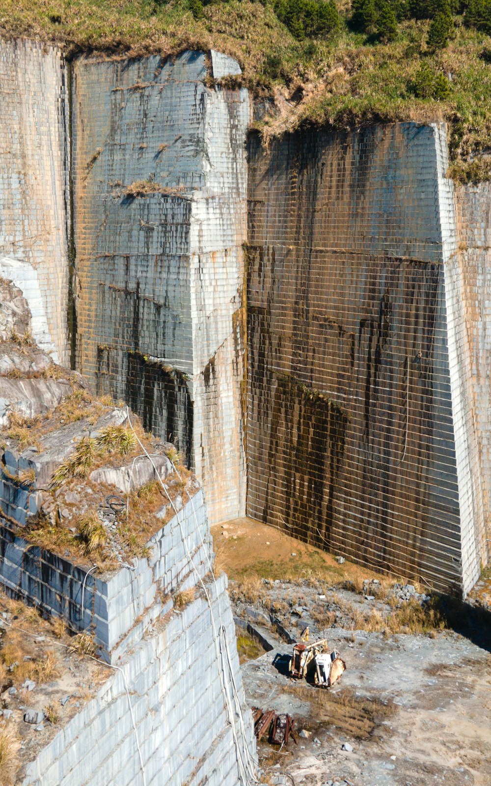 a group of people sitting on the edge of a cliff