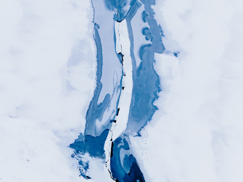 an aerial view of a river in the snow