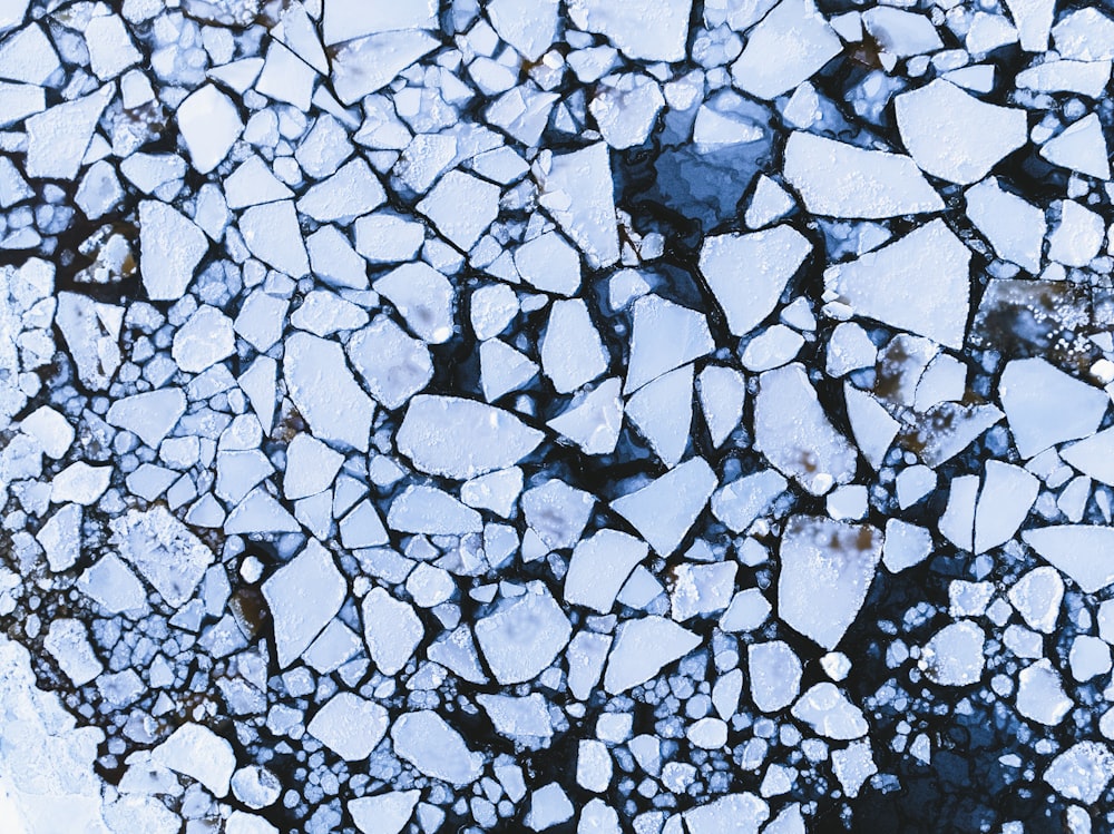 an aerial view of ice chunks on the water
