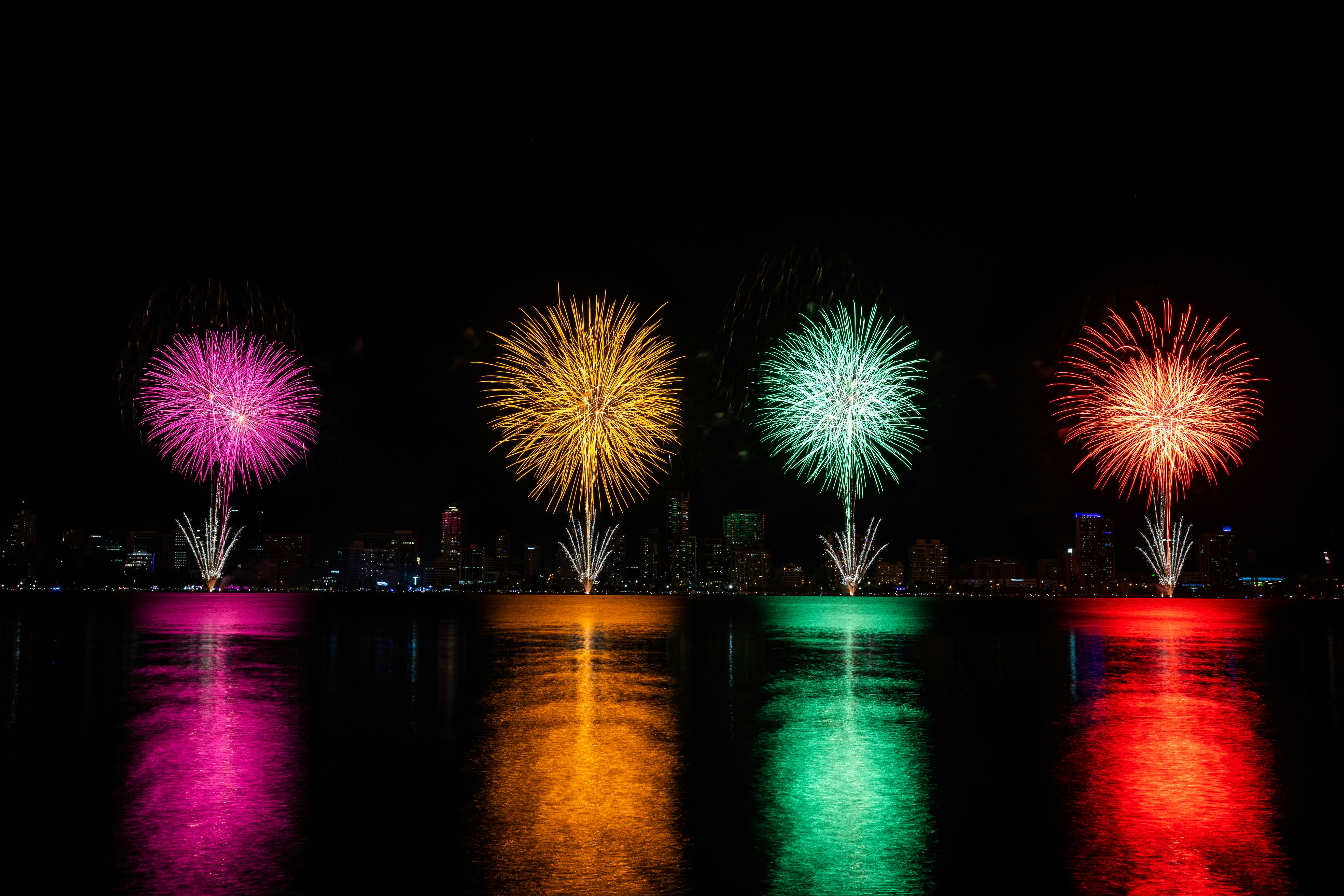 a group of fireworks are lit up in the night sky