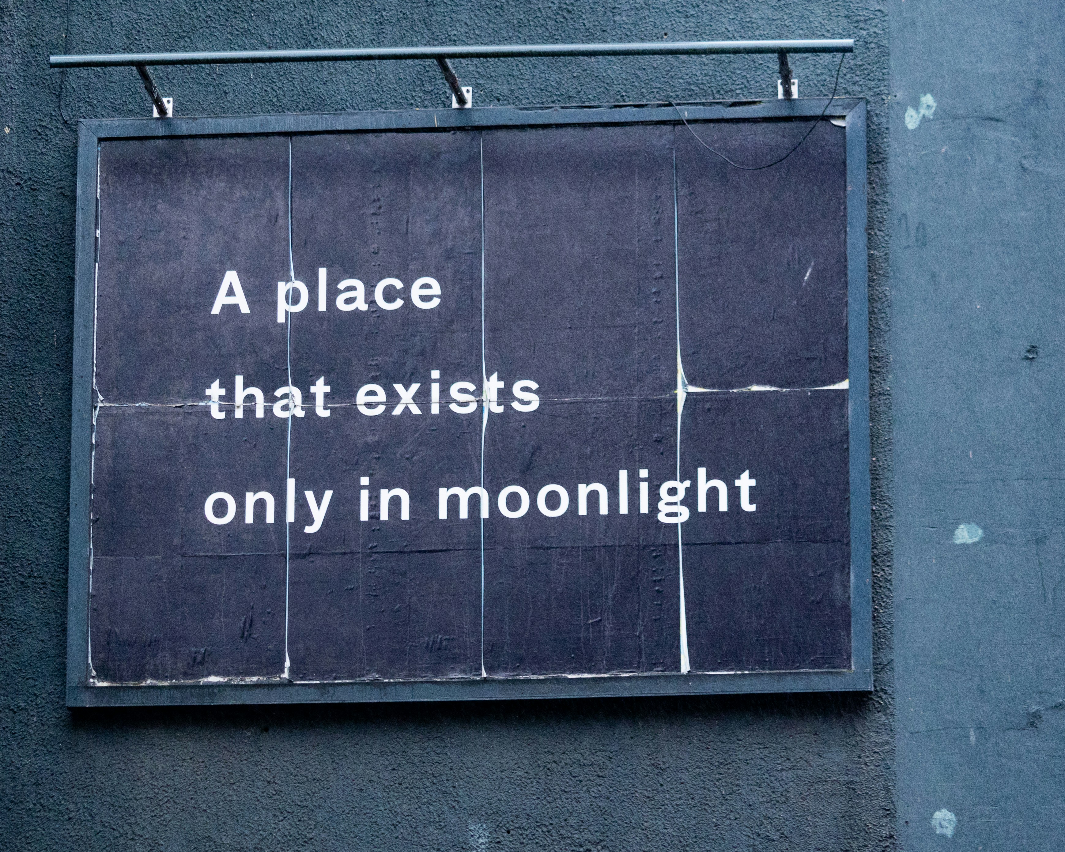 a sign on the side of a building that says a place that exits only in (Photo by Andrew Dawes on Unsplash)