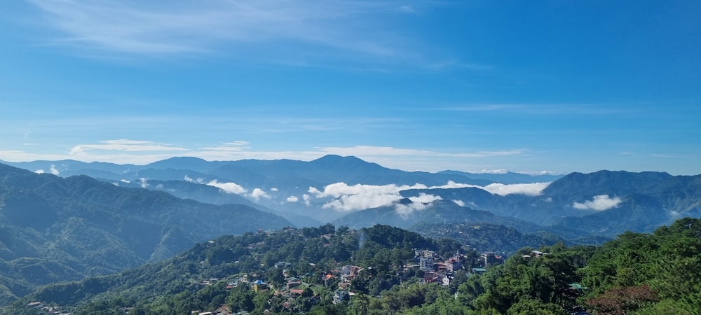 a scenic view of a city surrounded by mountains