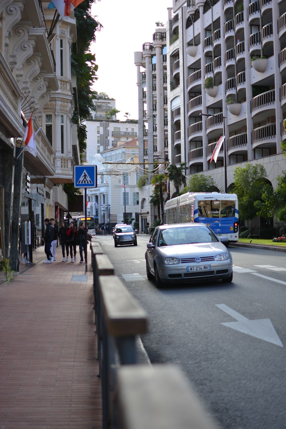 a car driving down a street next to tall buildings