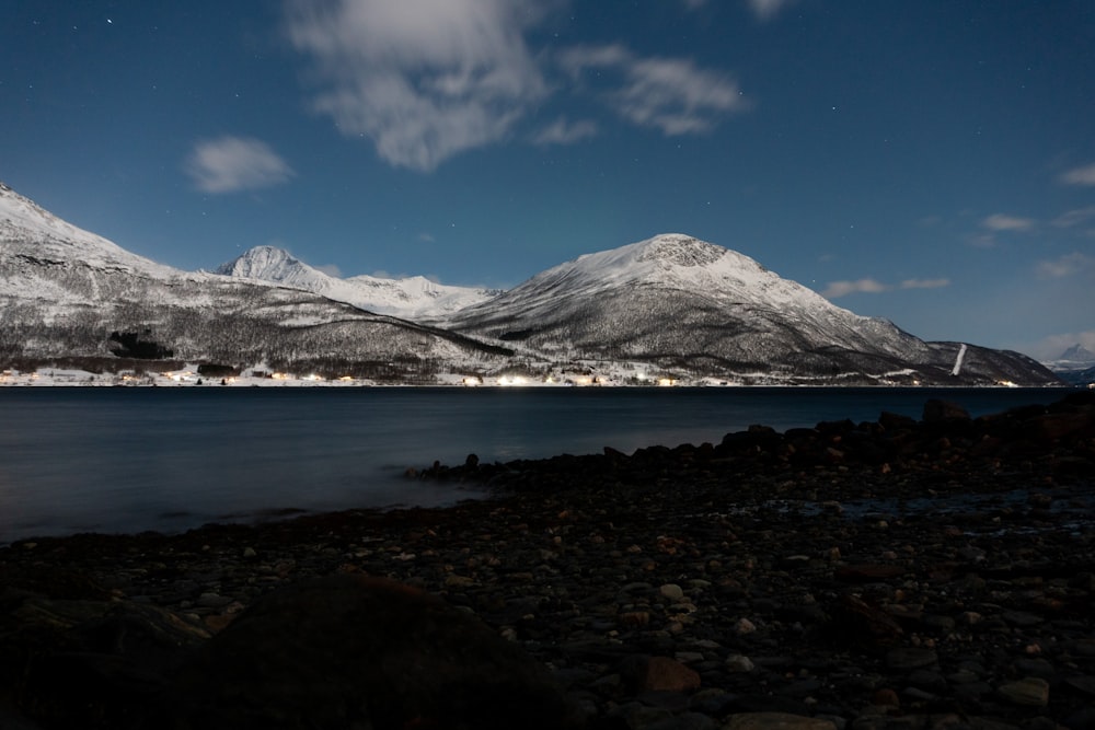 a mountain range with a body of water in the foreground